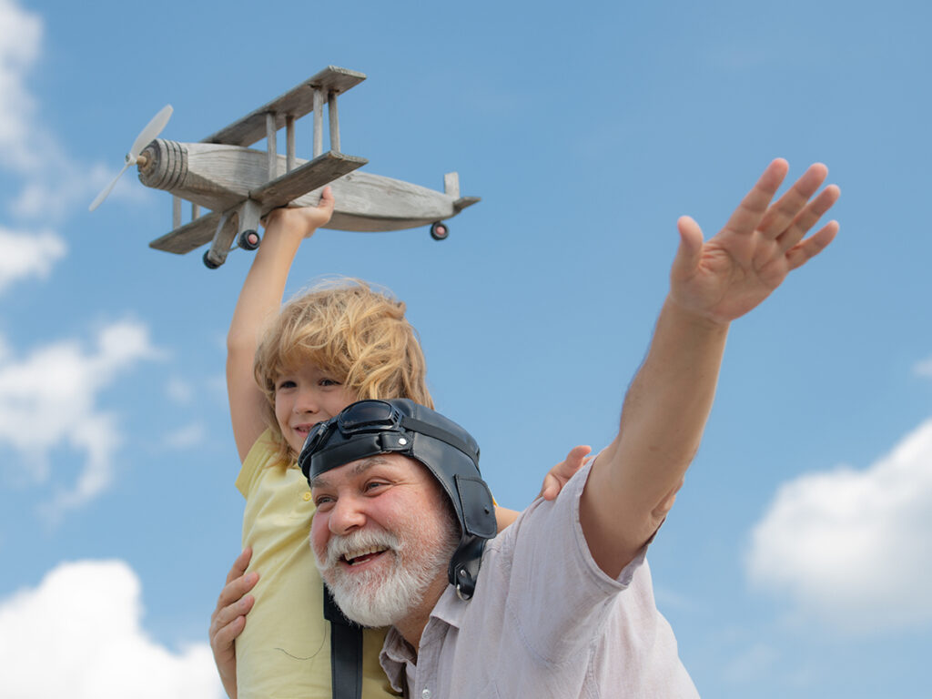 Abuelo y nieto jugando con un avión