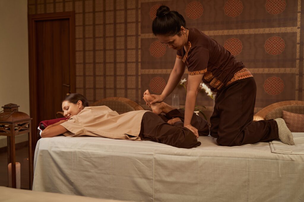 Femme asiatique effectuant un massage thaïlandais à une autre femme
